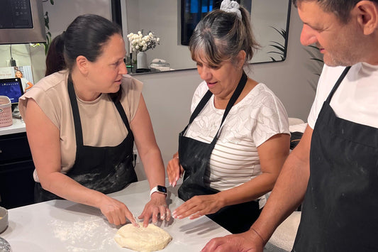 Chef Efrat guiding students through dough shaping in a sourdough workshop