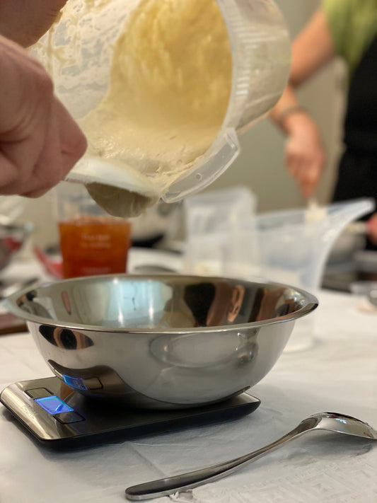 Pouring active sourdough starter during a live ERNEY demonstration